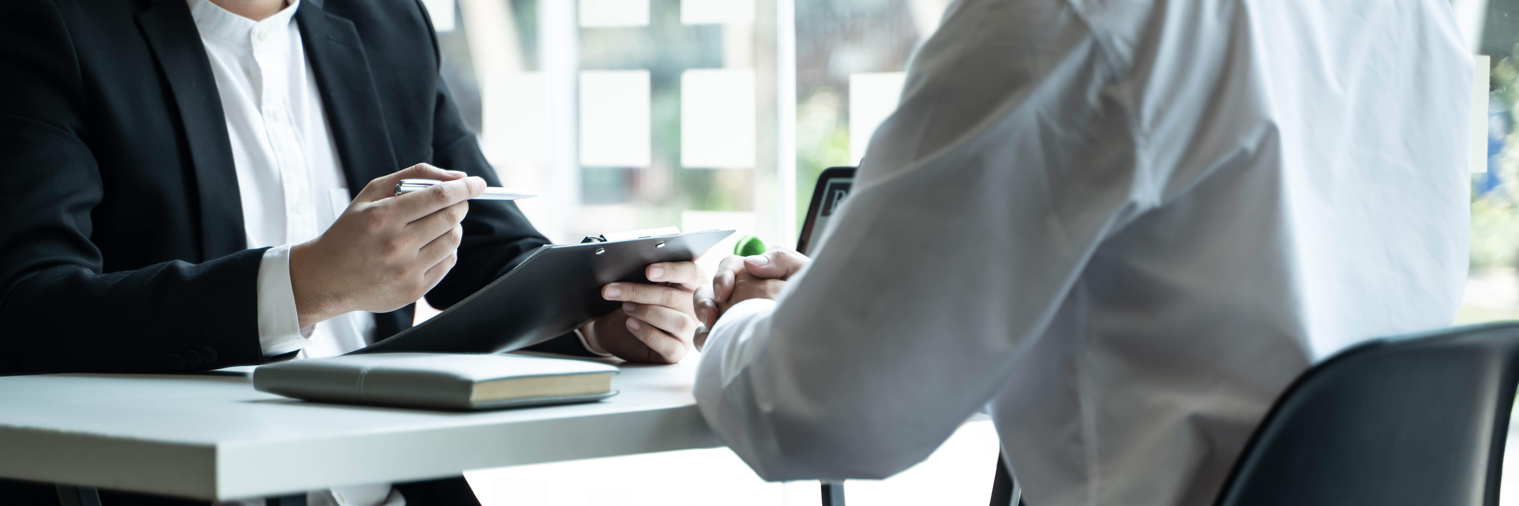 smartly dressed workers sat at a desk